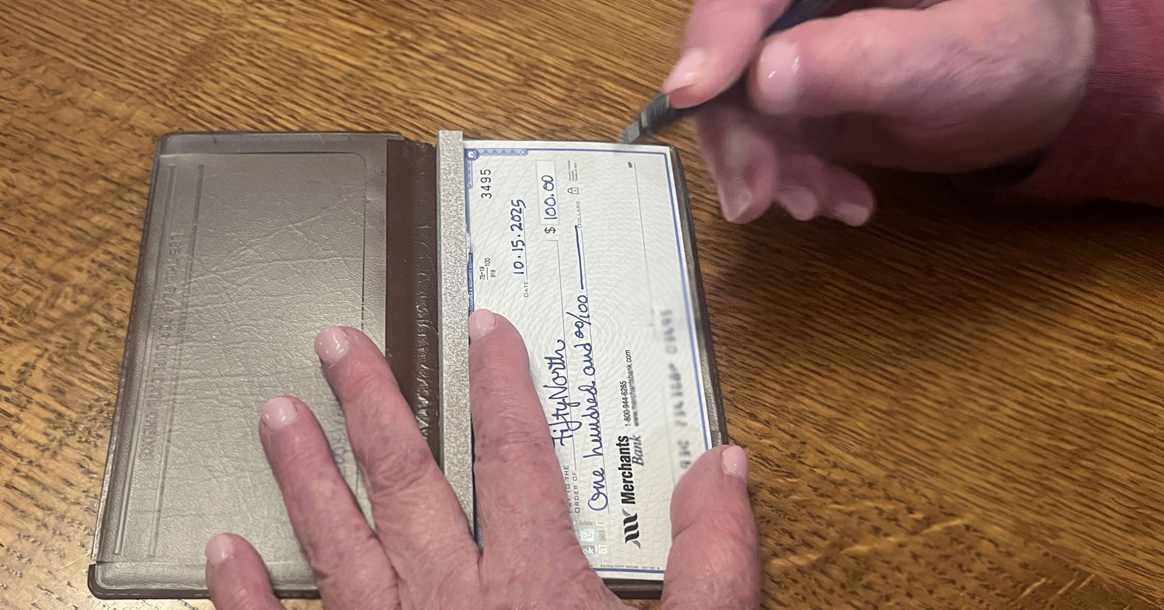 Woman making a donation to FiftyNorth