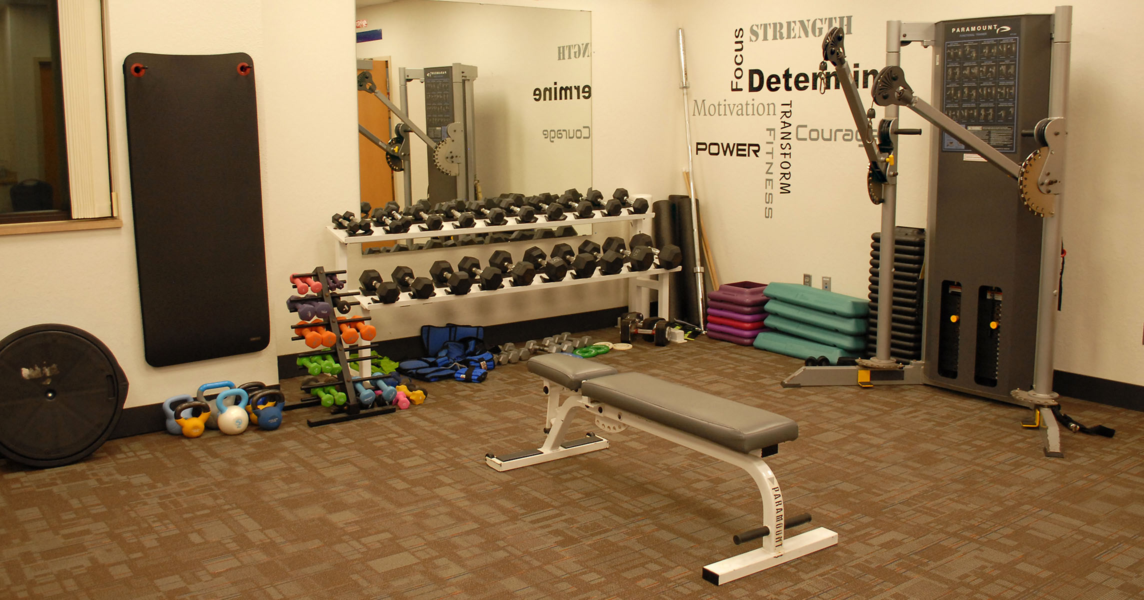 Functional fitness room with free weights and bench