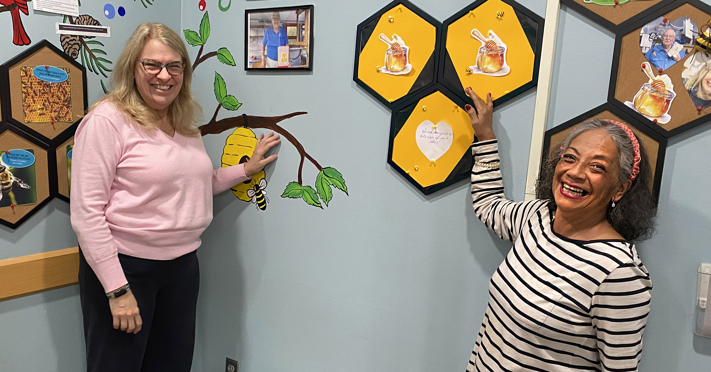 Two women decorating volunteer corner